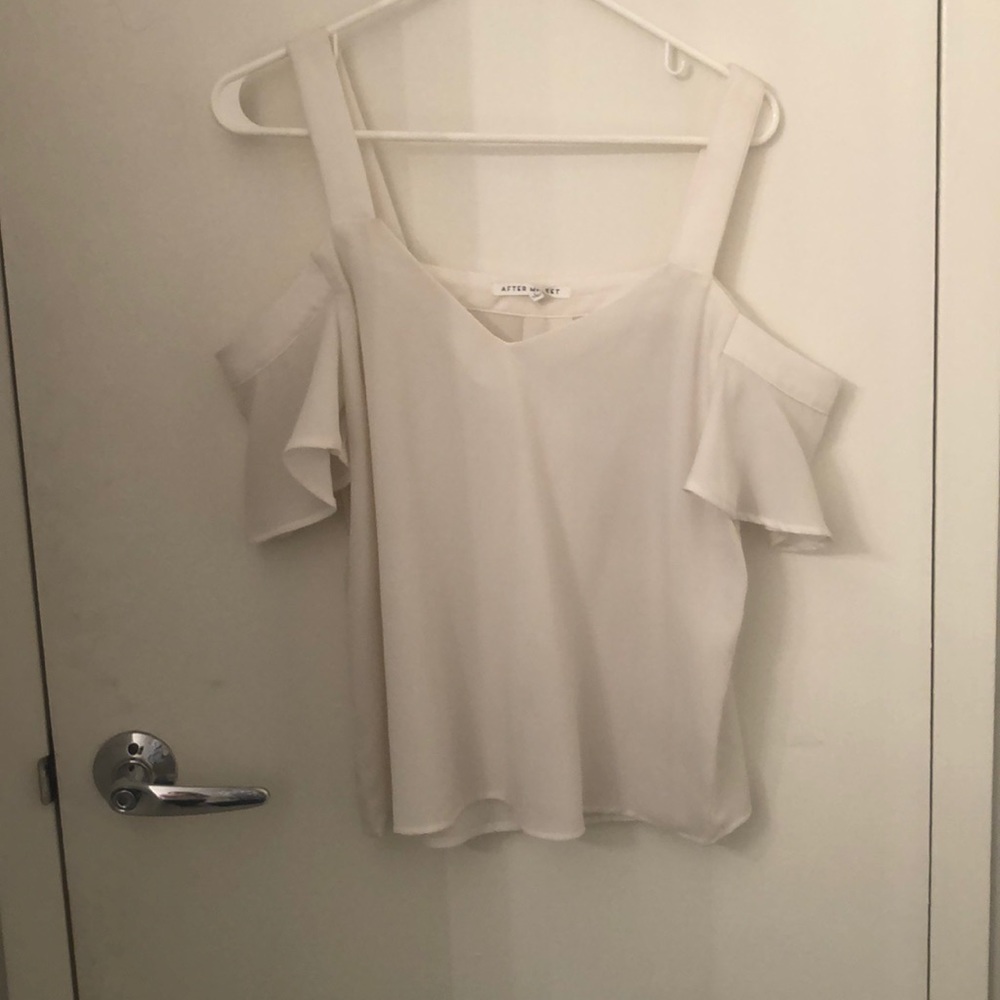 Ivory colored flowy top with shoulder cut out